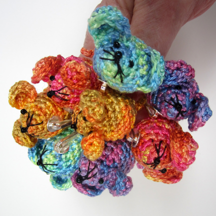 a handful of crochet mice hair ornaments