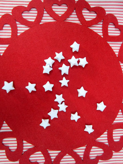 white origami stars on red Origami Stars -  Day three Planet Penny Advent Calendar