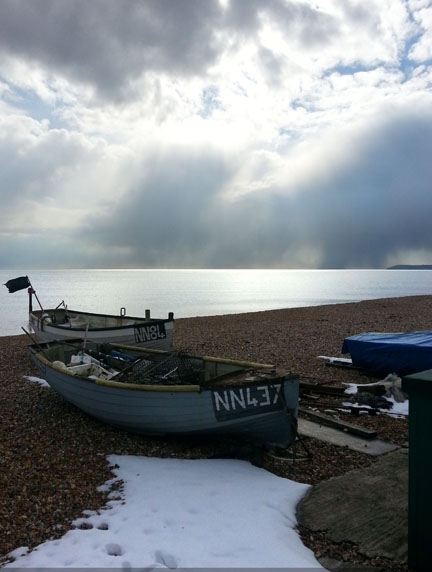 boats and snow at the seaside